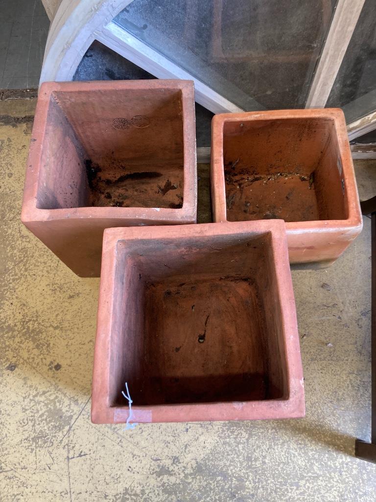 Three square terracotta planters, largest 36cm wide, height 40cm